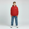 Enfant portant le hoodie rouge Charles Leclerc, vue de face, logo Tourismo poitrine, coupe droite, mains relâchées, fond studio clair.