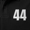 Nahaufnahme der weiß gestickten 44 auf dem Lewis Hamilton Polo in Schwarz